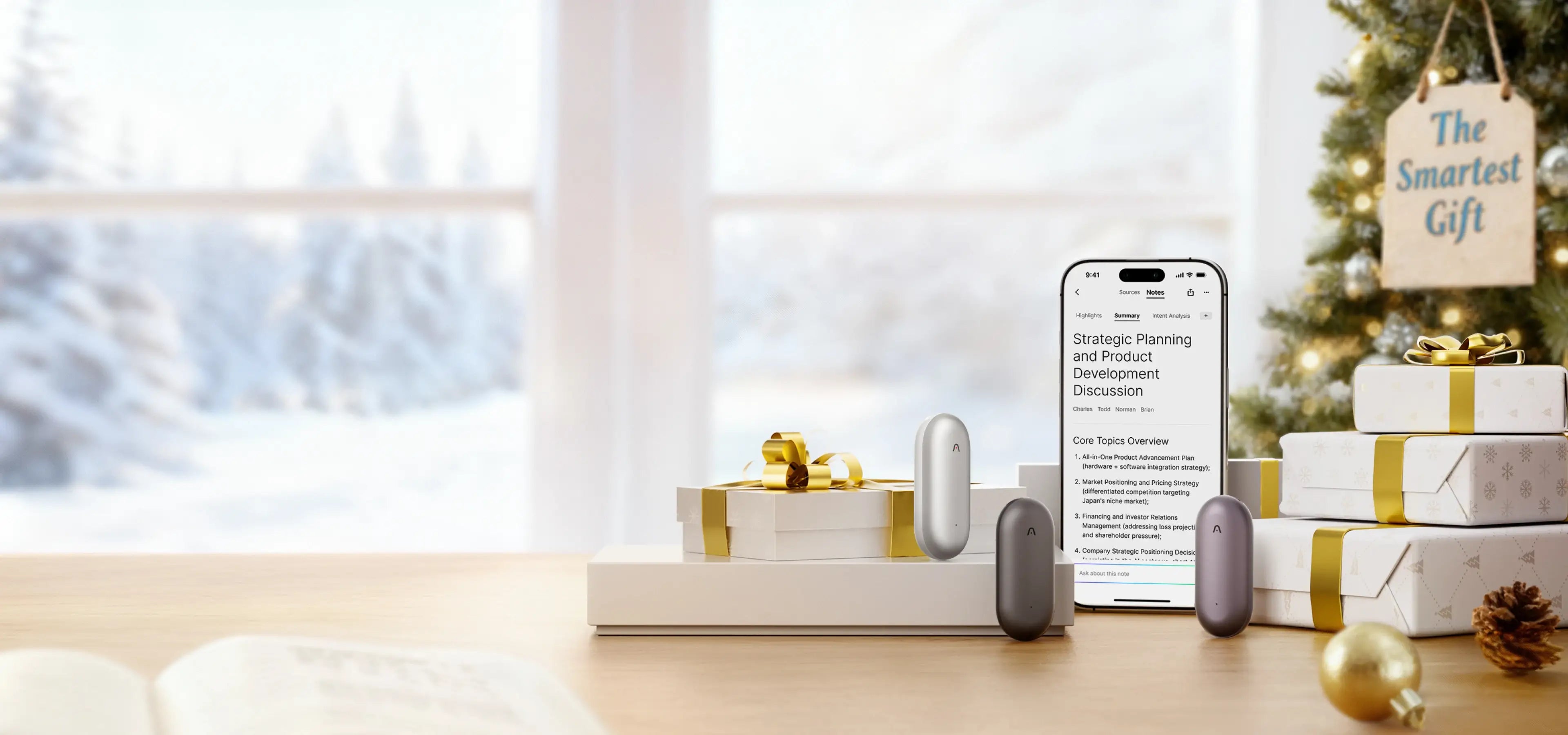 Plaud NotePin devices and a phone with the Plaud App are Christmas gifts on a table with a festive tree.