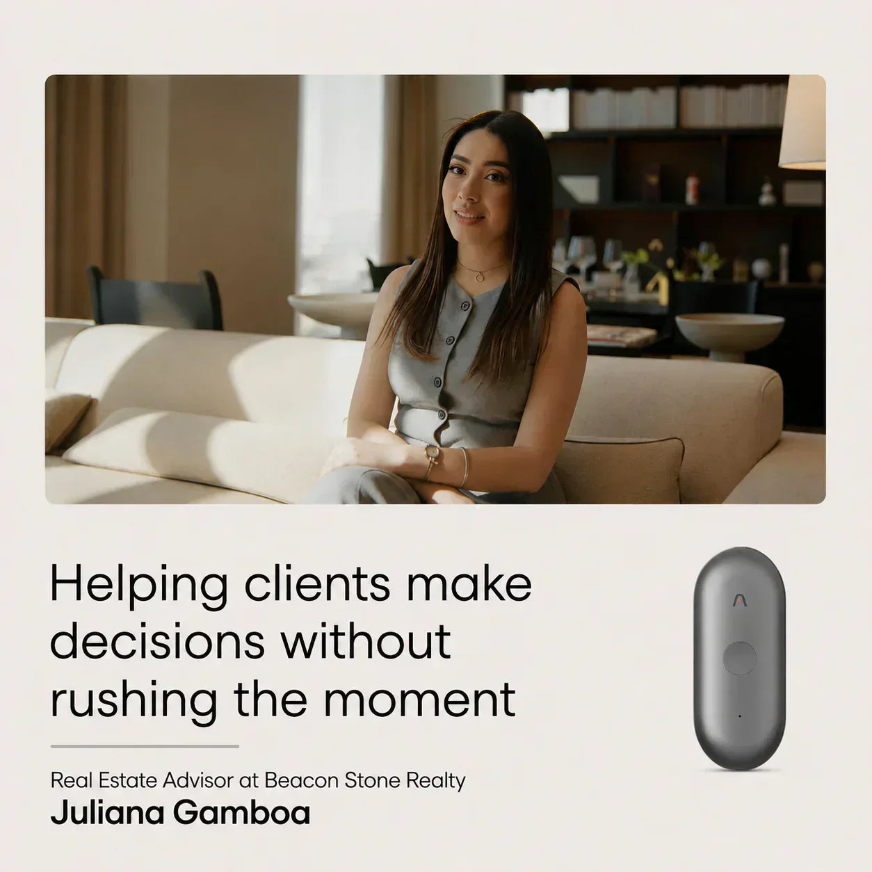 A smiling woman in a grey dress sits on a sofa, alongside a dark grey Plaud NotePin S AI voice recorder, conveying profession