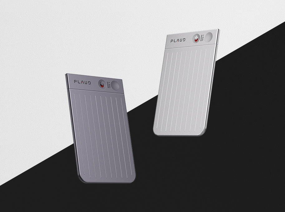 Two Plaud Note devices, one silver and one dark gray, are angled against a diagonally split black and white background.