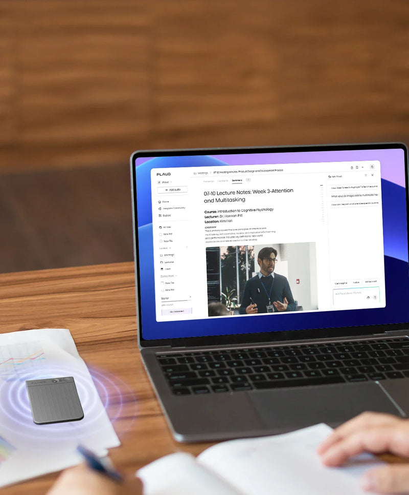 A person writes in a notebook at a wooden desk, with a silver laptop displaying the Plaud App showing lecture notes, and a da