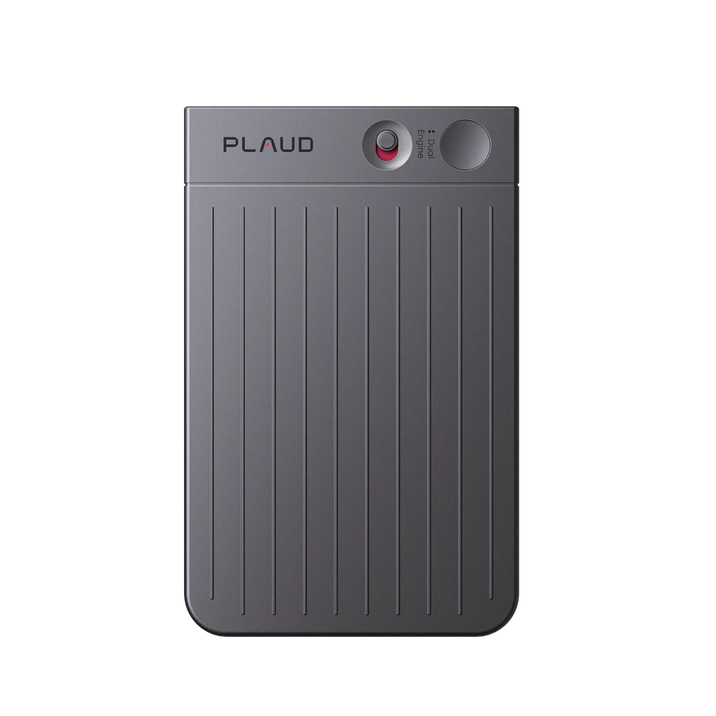 A dark black Plaud Note AI voice recorder is shown from above, featuring a red record dial and ribbed texture.